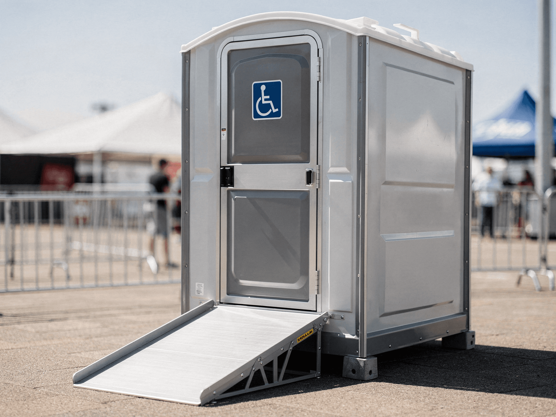 ADA-compliant portable toilet with wider door and ramp